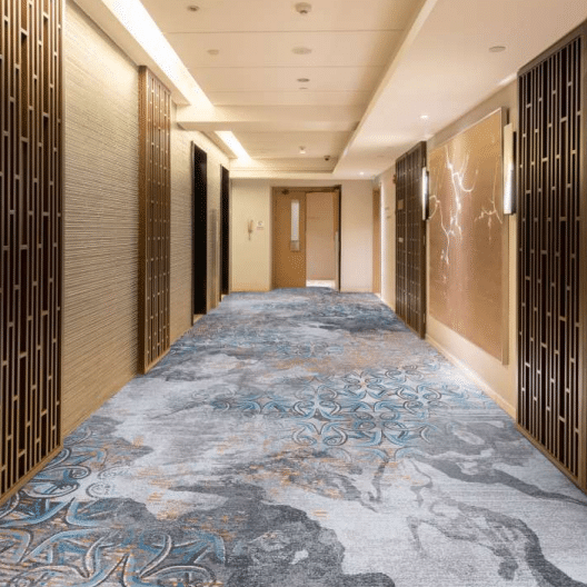 Hotel corridor with gray and blue patterned Wilton carpet
