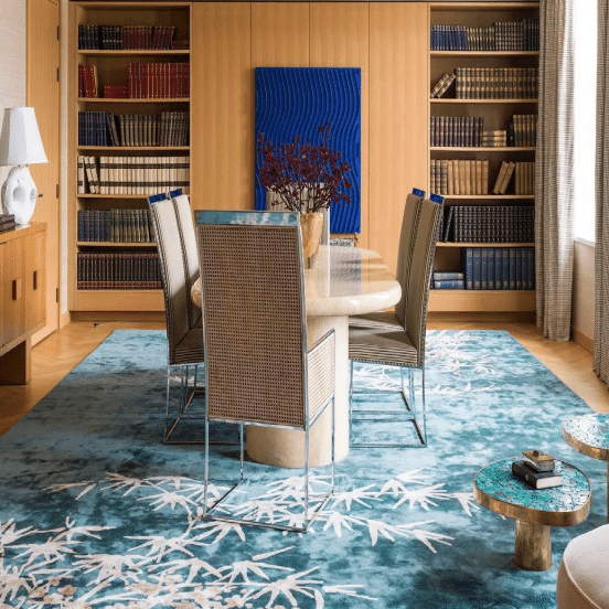 Dining room with custom hand tufted carpet featuring bamboo leaf patterns on a blue-green background