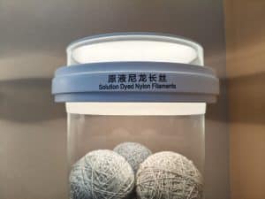 SENNIU solution dyed nylon filaments in light gray yarn balls displayed in a clear container