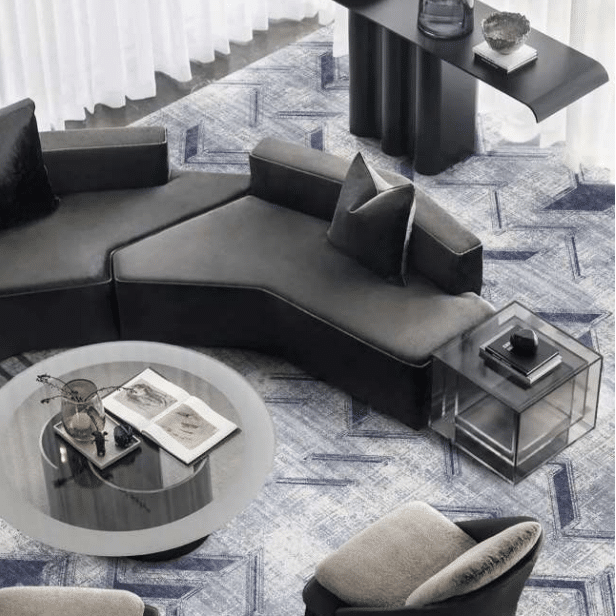Contemporary lounge with gray Wilton carpet in abstract blue herringbone pattern
