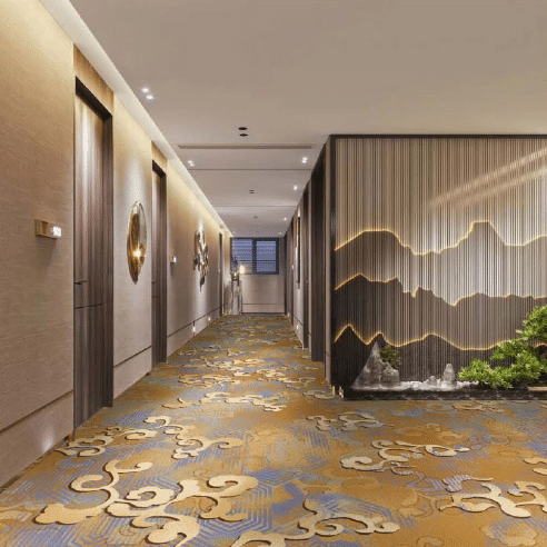 Hotel corridor with gold and blue printed carpet featuring swirling cloud patterns