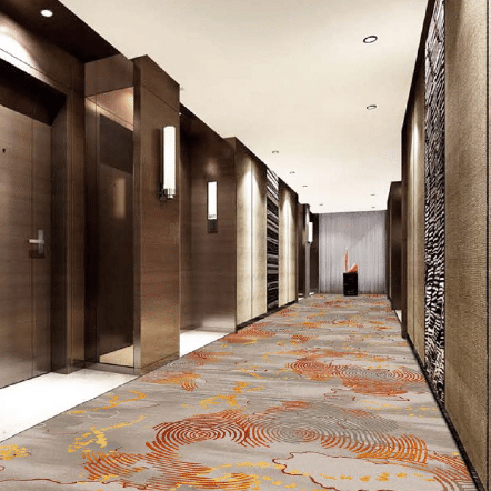 Hotel elevator lobby with gray and orange printed carpet in circular ripple patterns