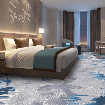 Modern hotel suite with printed carpet featuring white swirling circles on a blue gradient base