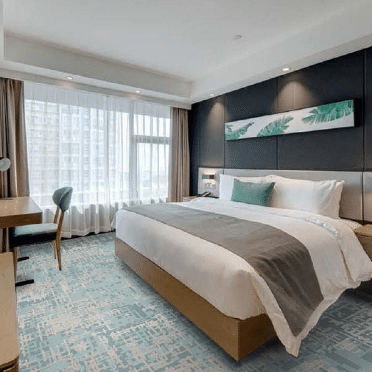 Modern minimalist hotel room with light blue and white pixel grid printed carpet
