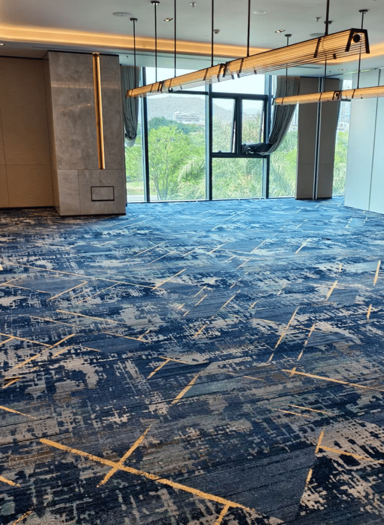 Axminster corridor carpet featuring wave motifs for high-traffic hotel areas.