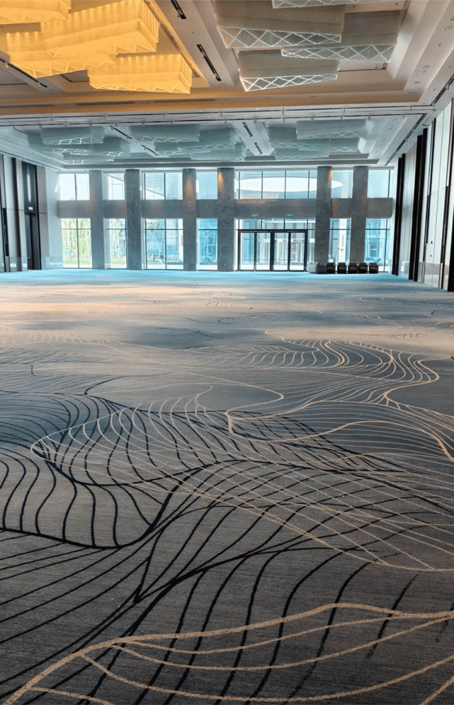 Axminster corridor carpet featuring wave motifs for high-traffic hotel areas.