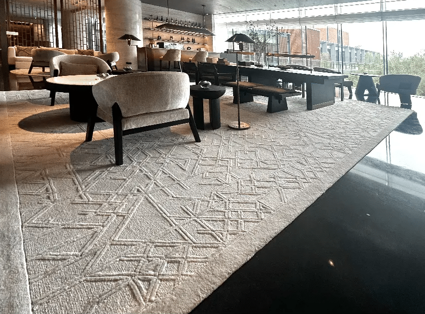 Custom Chinese ink-wash patterned hand-tufted wool carpet by QIANQIAO in the grand lobby of Crowne Plaza Beijing Tongzhou hotel.
