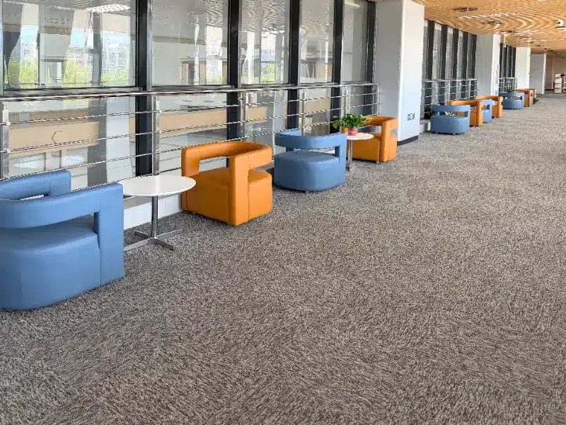 Seamless installation of QIANQIAO gray square carpet tiles on the floor of a school library in Shandong, China