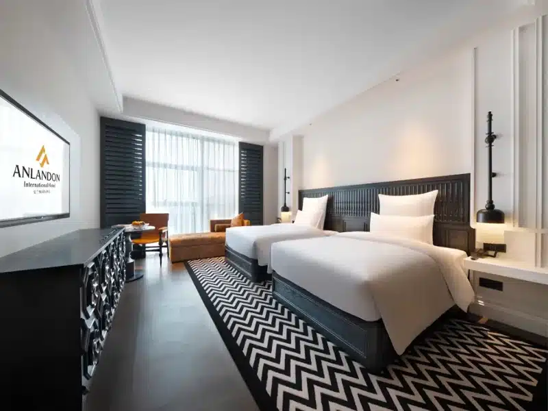Black and white geometric pattern hotel guestroom carpet by QIANQIAO for a French classical luxury room design.